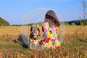 Young woman sitting with her dog
