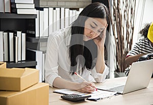 Young woman sitting in a home office with her laptop, Stressful