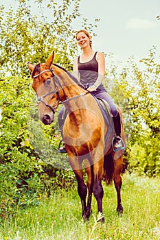 Young woman sitting on a horse