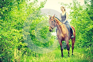 Young woman sitting on a horse