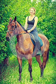 Young woman sitting on a horse