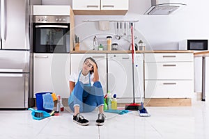 Young Woman Sitting On Kitchen Floor