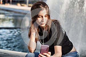 Young woman sitting and listening to her music