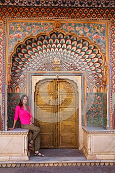 Young woman sitting at Lotus Gate in Pitam Niwas Chowk, Jaipur C