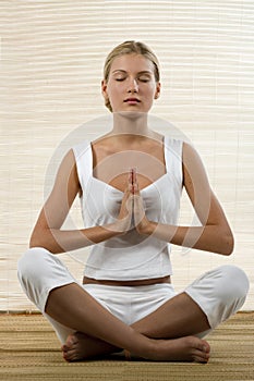 Young woman sitting in lotus position