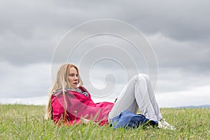 Young woman sitting on meadow