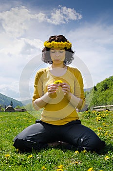 Young woman sitting in a meadow