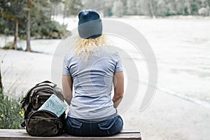 Young woman sitting in the National Park. To dream of looking at