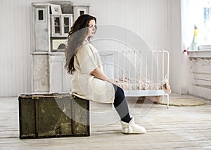 Young woman sitting on the old bag