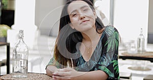 Young woman sitting in outdoor restaurant