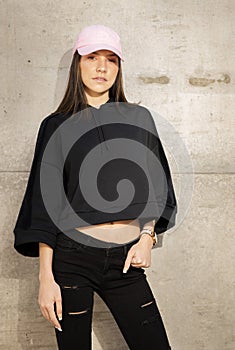 Young woman sitting outside on steps wearing cool fashionable clothing