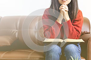 Young woman sitting and praying in the morning