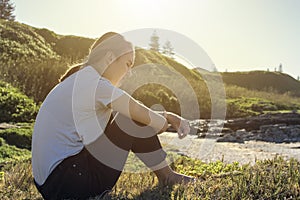 Young woman sitting and relaxing in morning sun