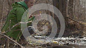 Young woman sitting on the river bank