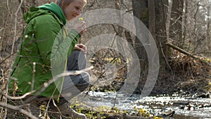 Young woman sitting on the river bank