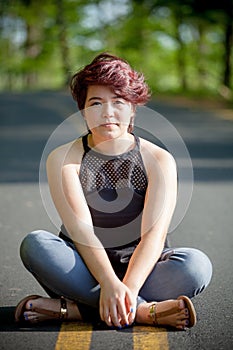 Young Woman Sitting in the Road