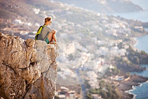 Young woman sitting on rock