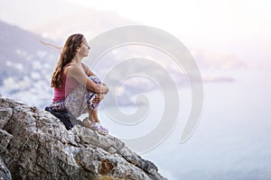 Young woman sitting on rock