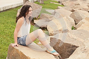 Young woman sitting on the rocks