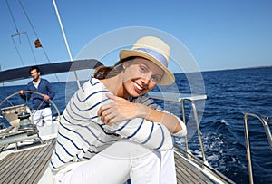 Young woman sitting on sailing boat cruising
