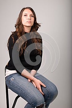 Young Woman Sitting on Stool