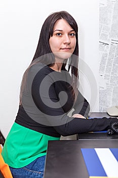 Young woman sitting at table