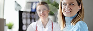 Young woman sitting at table at doctor appointment