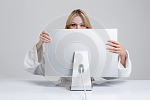 Young woman sitting in the table and using computer