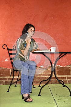 Young Woman Sitting and Talking on Cellphone