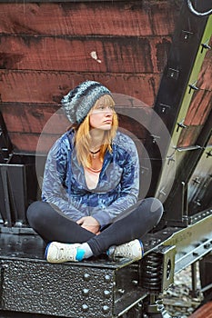 Young woman sitting on a train wagon