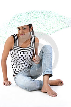 Young woman sitting with umbrella isolated o