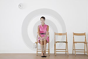 Young Woman Sitting In Waiting Room