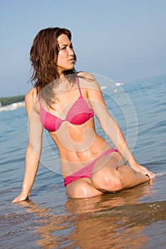 A young woman is sitting in the water