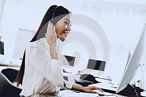 Young Woman Sitting and Working in Call Center. Manager with Computer. Girl on Workplace. Consultant with Microphone. Customer