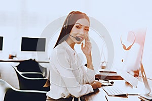 Young Woman Sitting and Working in Call Center. Manager with Computer. Girl on Workplace. Consultant with Microphone. Customer