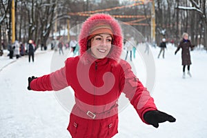 Young woman on skating rink in park