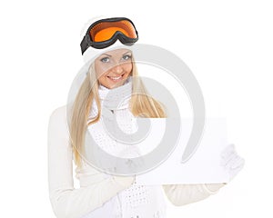 Young woman in ski glasses with empty board for the text.