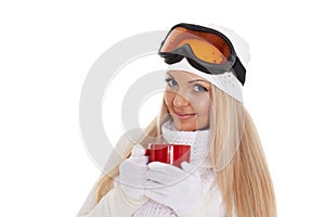 Young woman in ski glasses with red cup