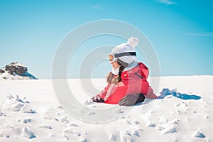 Young woman skier enjoying the snow sunbathing