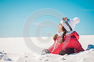 Young woman skier enjoying the snow sunbathing