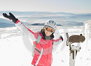 Young woman skier at ski resort in mountains