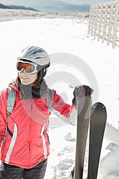 Young woman skier at ski resort in mountains