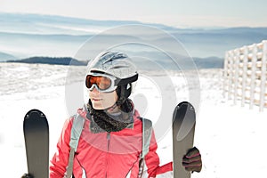 Young woman skier at ski resort in mountains