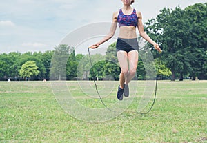 Young woman skipping in the park