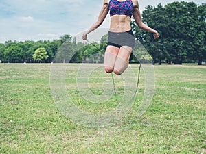 Young woman skipping in the park