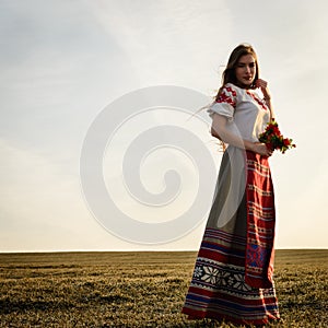 Young woman in Slavic Belarusian national original suit outdoors