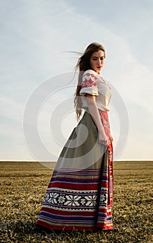 Young woman in Slavic Belarusian national original suit outdoors