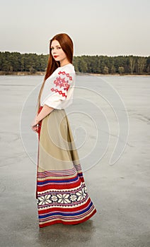 Young woman in Slavic Belarusian national original suit outdoors