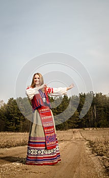 Young woman in Slavic Belarusian national original suit outdoors