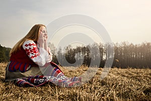 Young woman in Slavic Belarusian national original suit outdoors